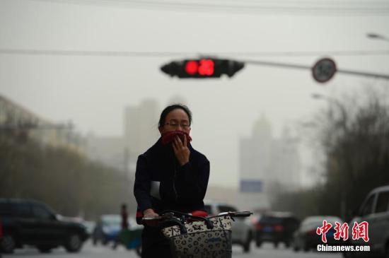 资料图:雾霾天,出行的民众用围巾掩住口鼻。。 记者 刘文华 摄 环保“督察高压”步入常态化 约谈通报问责齐上阵